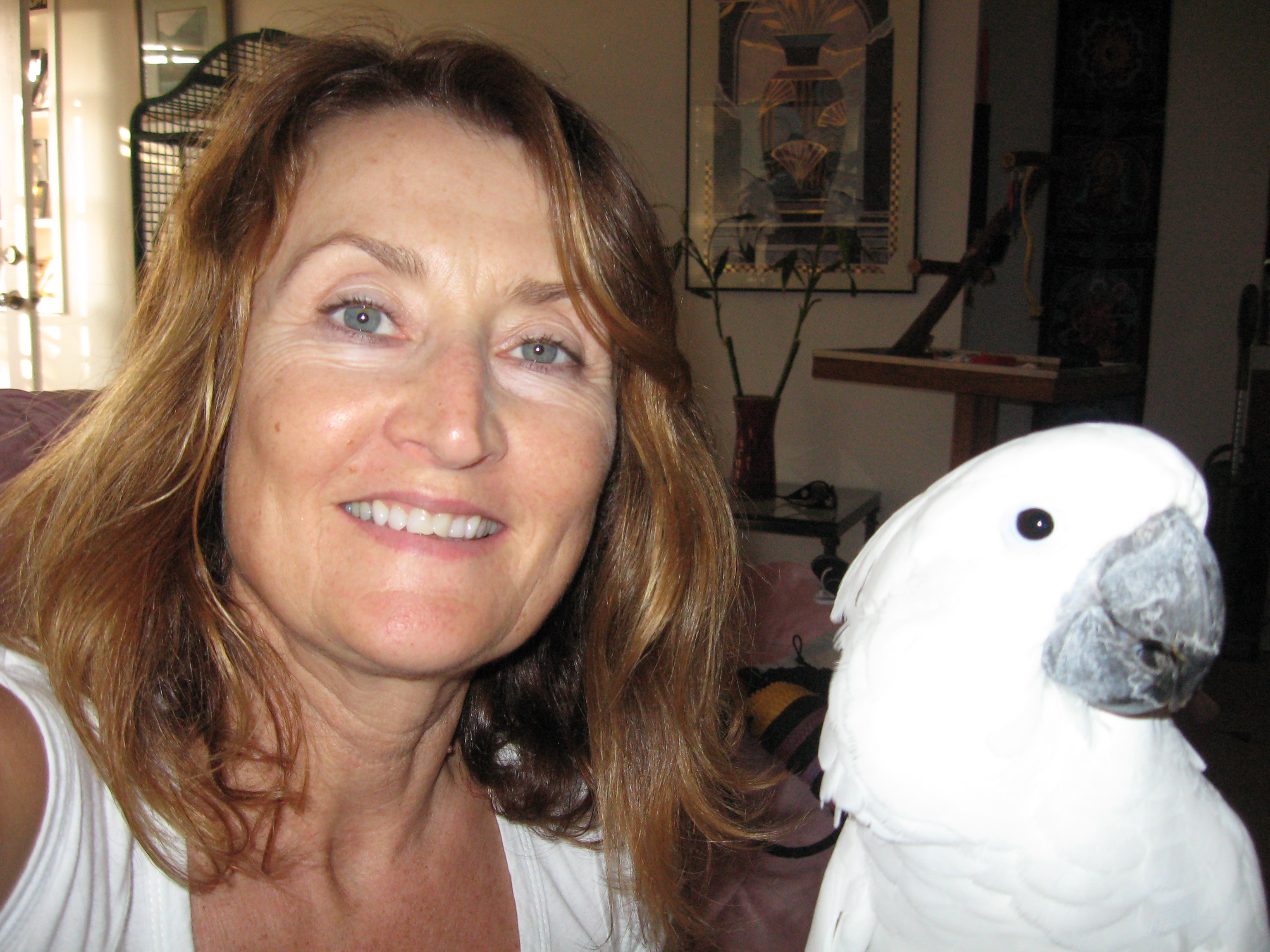 Deborah and her beloved white cockatoo named Dutch